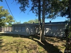 rear view of property with a yard