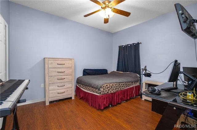 bedroom with ceiling fan and dark hardwood / wood-style flooring