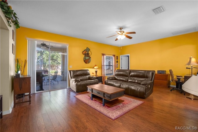 living room featuring ceiling fan and dark hardwood / wood-style flooring