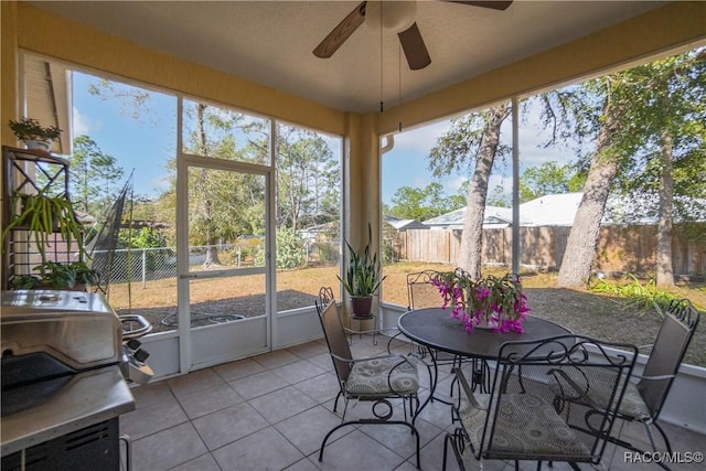 sunroom featuring ceiling fan