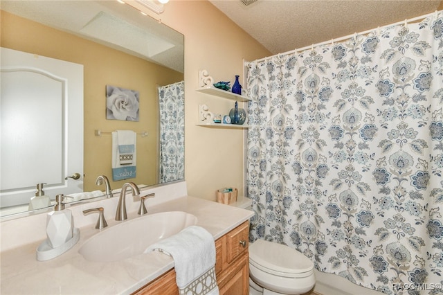 bathroom featuring vanity, a textured ceiling, and toilet