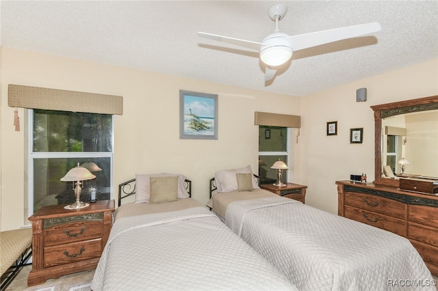 bedroom featuring a textured ceiling and ceiling fan