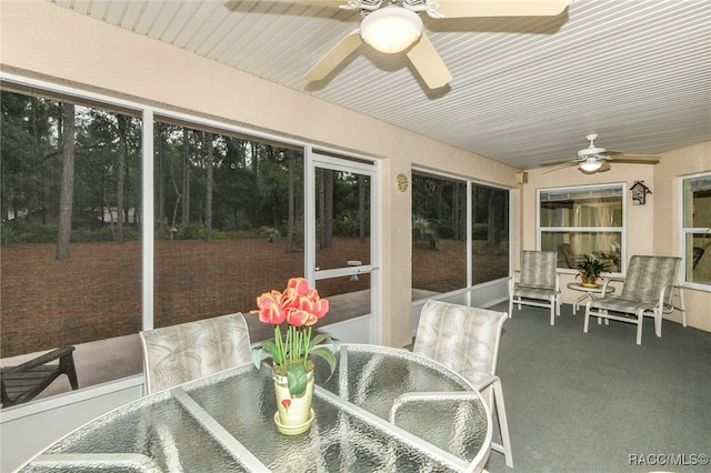 sunroom featuring ceiling fan