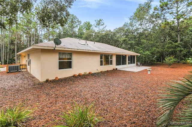 rear view of property featuring a patio area and central AC