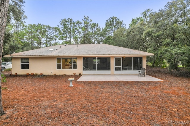 rear view of property with a patio area and a sunroom