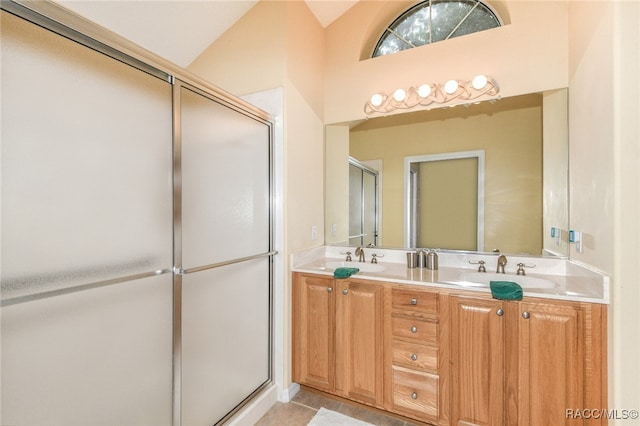 bathroom featuring tile patterned flooring, vanity, a shower with shower door, and high vaulted ceiling