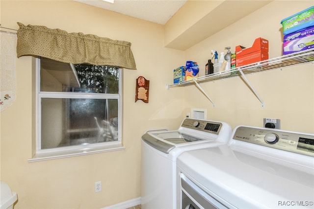 laundry room with washing machine and clothes dryer