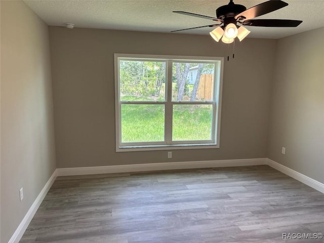 10185 N Halsey Way, Citrus Springs, FL 34434 - spare room featuring a ceiling fan, wood finished floors, baseboards, and a textured ceiling