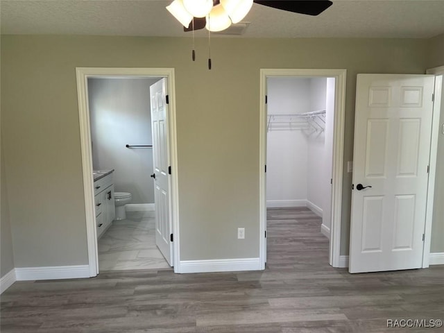 10185 N Halsey Way, Citrus Springs, FL 34434 - unfurnished bedroom with a closet, a spacious closet, connected bathroom, and baseboards