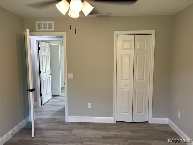 10185 N Halsey Way, Citrus Springs, FL 34434 - unfurnished bedroom with baseboards, wood finished floors, a closet, and ceiling fan