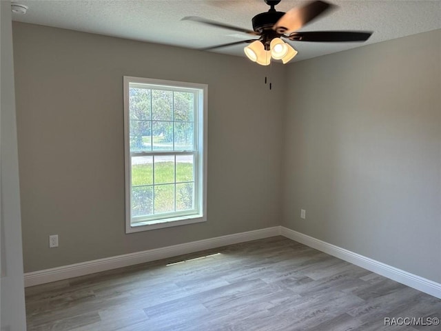 10185 N Halsey Way, Citrus Springs, FL 34434 - spare room featuring healthy amount of natural light, a ceiling fan, wood finished floors, and a textured ceiling