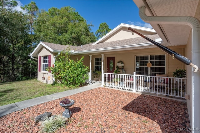 ranch-style house featuring a porch and a front lawn