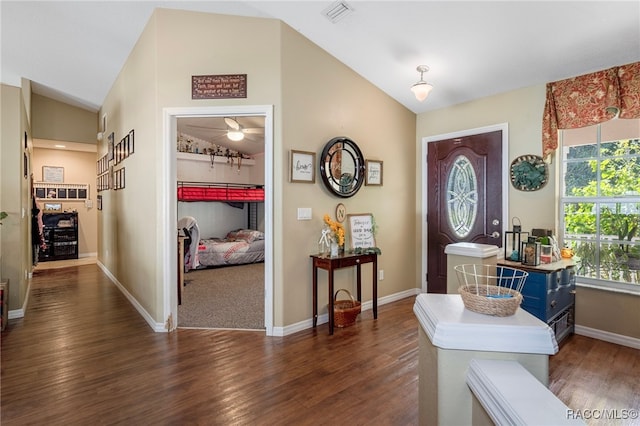 entrance foyer with dark hardwood / wood-style floors and high vaulted ceiling