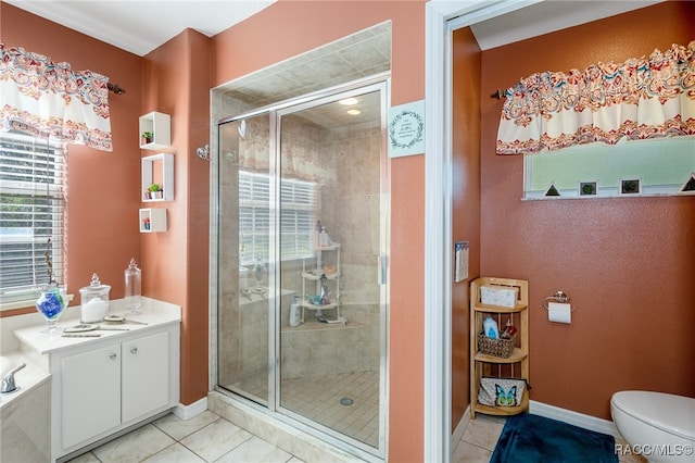 bathroom featuring tile patterned floors, vanity, a shower with shower door, and toilet