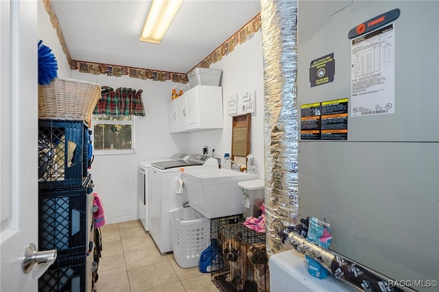 washroom featuring cabinets, sink, separate washer and dryer, a textured ceiling, and heating unit