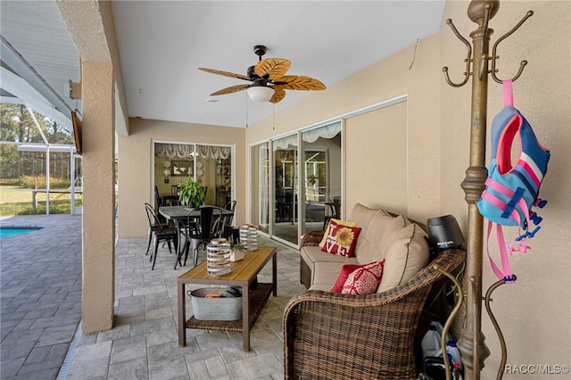 sunroom / solarium featuring ceiling fan