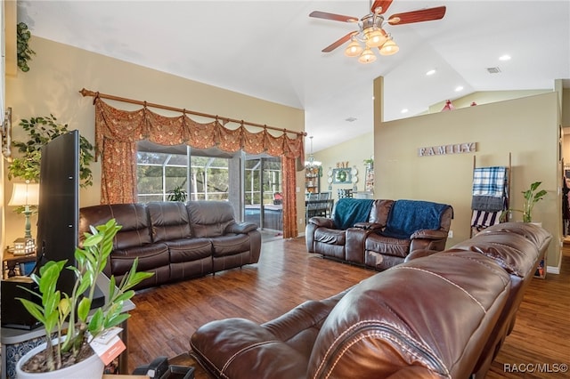 living room featuring dark hardwood / wood-style floors, vaulted ceiling, and ceiling fan