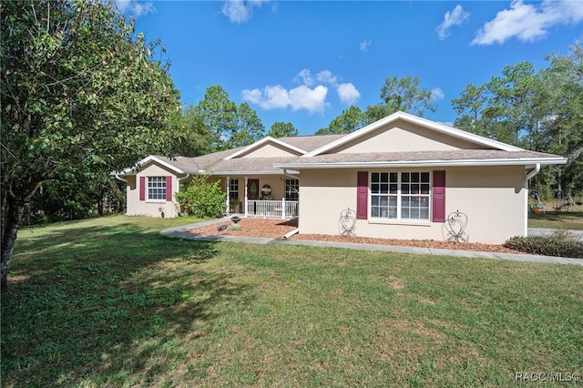 single story home featuring covered porch and a front yard