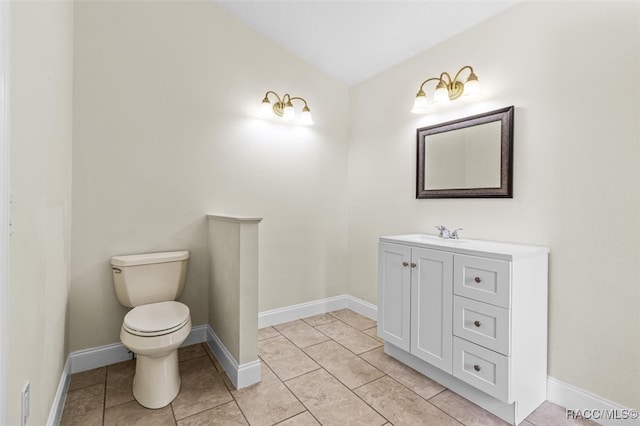 bathroom with tile patterned flooring, vanity, toilet, and lofted ceiling