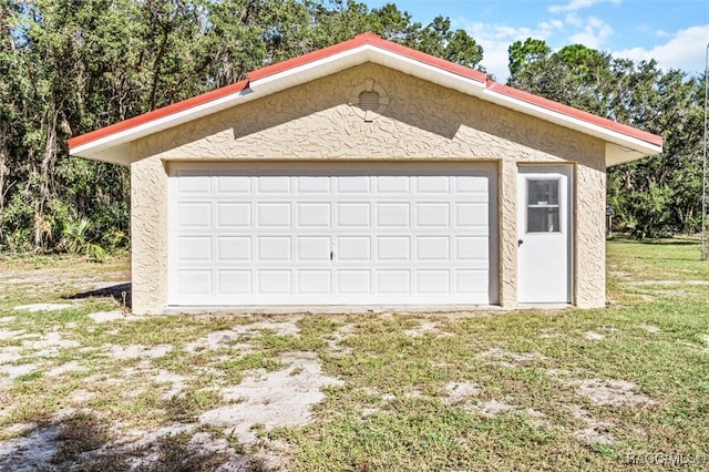 garage featuring a lawn