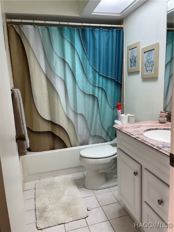 full bathroom featuring tile patterned flooring, vanity, toilet, and shower / bath combo