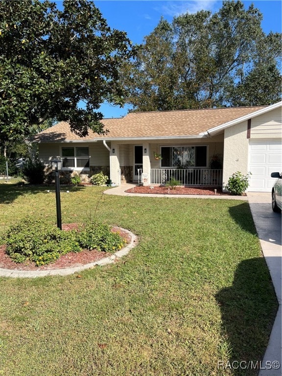 ranch-style home with covered porch, a garage, and a front lawn