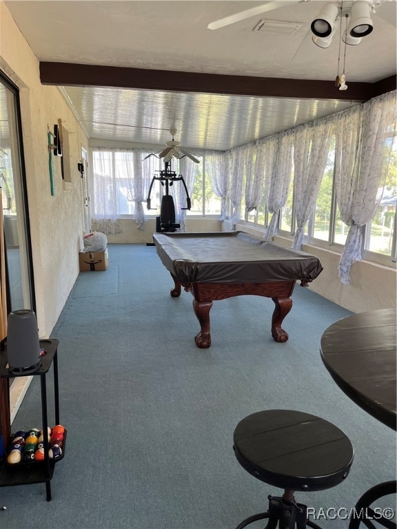 recreation room with beamed ceiling, carpet flooring, a healthy amount of sunlight, and pool table