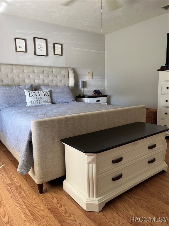 unfurnished bedroom featuring a textured ceiling and light wood-type flooring