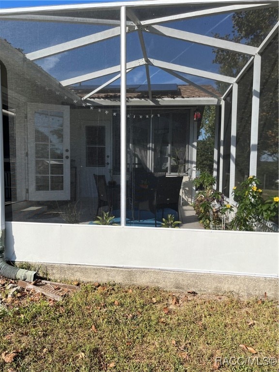 view of patio with glass enclosure