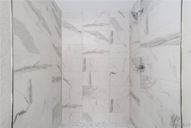 bathroom with a tile shower