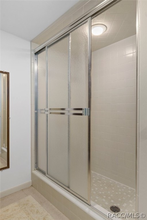 bathroom featuring tile patterned flooring and a shower with door