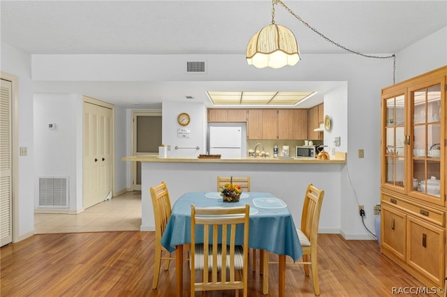 dining room featuring light hardwood / wood-style floors