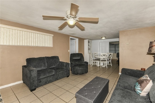 living room featuring ceiling fan and light tile patterned floors