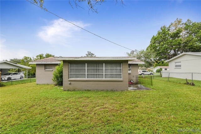 back of property featuring a lawn