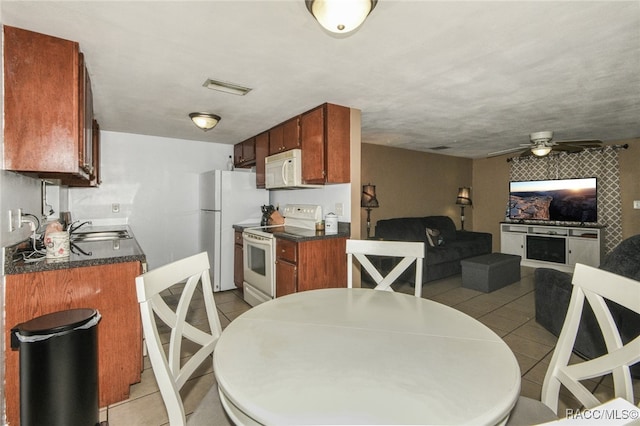 kitchen with ceiling fan, light tile patterned flooring, white appliances, and sink