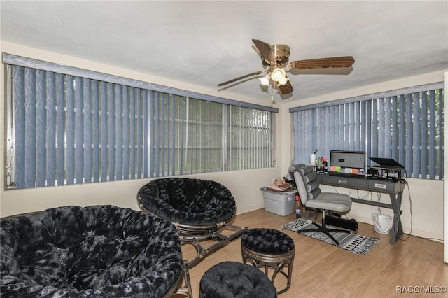 home office with hardwood / wood-style flooring and ceiling fan