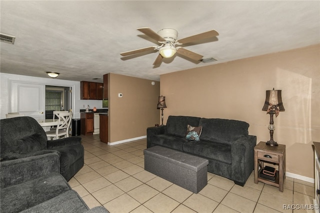 tiled living room with ceiling fan