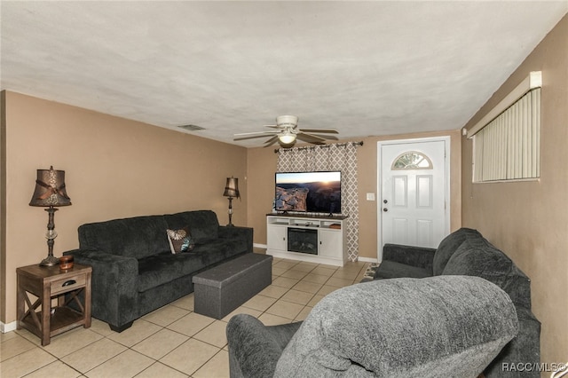 living room with ceiling fan and light tile patterned flooring