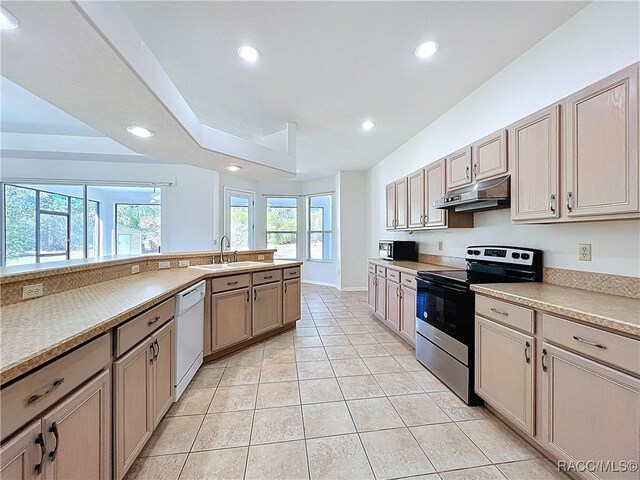 kitchen featuring under cabinet range hood, dishwasher, recessed lighting, stainless steel range with electric cooktop, and a sink