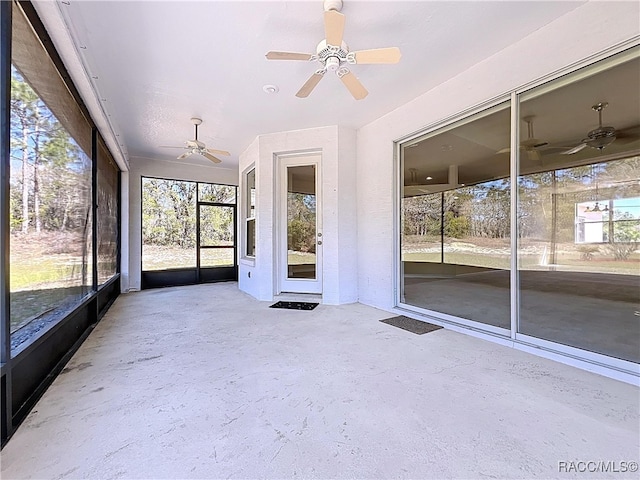 unfurnished sunroom featuring ceiling fan