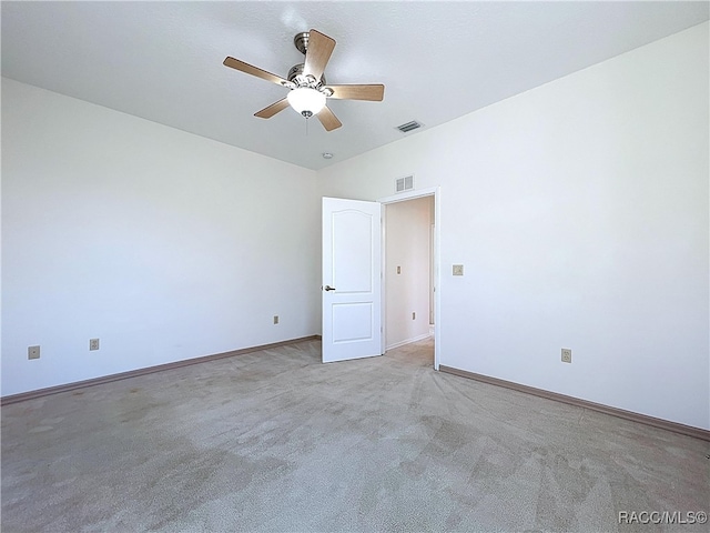 spare room featuring visible vents, carpet, baseboards, and ceiling fan