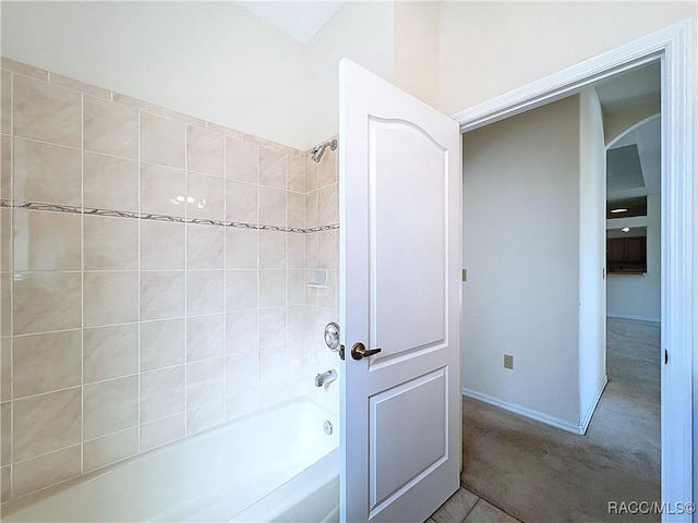 bathroom with tub / shower combination and baseboards