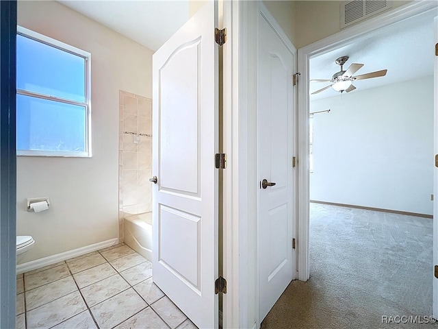 full bath featuring baseboards, visible vents, ceiling fan, tile patterned floors, and toilet