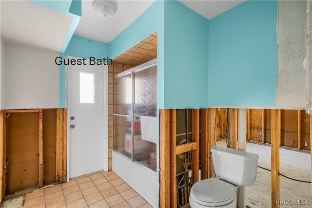 full bathroom featuring toilet, shower / bath combination with glass door, and tile patterned floors