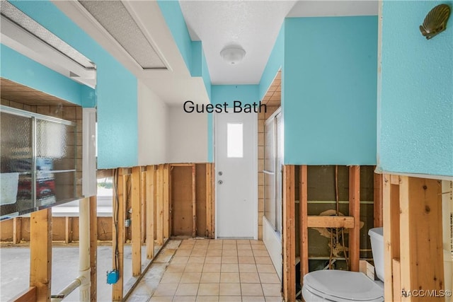 bathroom featuring tile patterned flooring and toilet