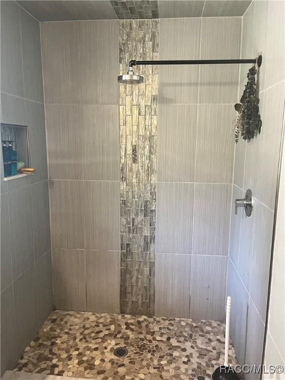 bathroom with tiled shower