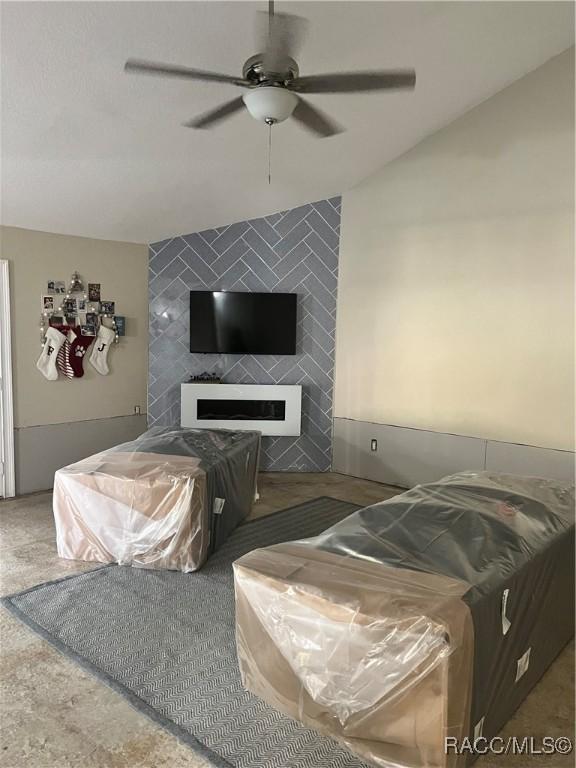 living room with a fireplace, carpet floors, and ceiling fan