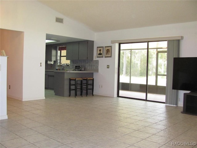 5198 N Sierra Vista Dr, Crystal River, FL 34428 - living area with lofted ceiling, healthy amount of natural light, and light tile patterned floors