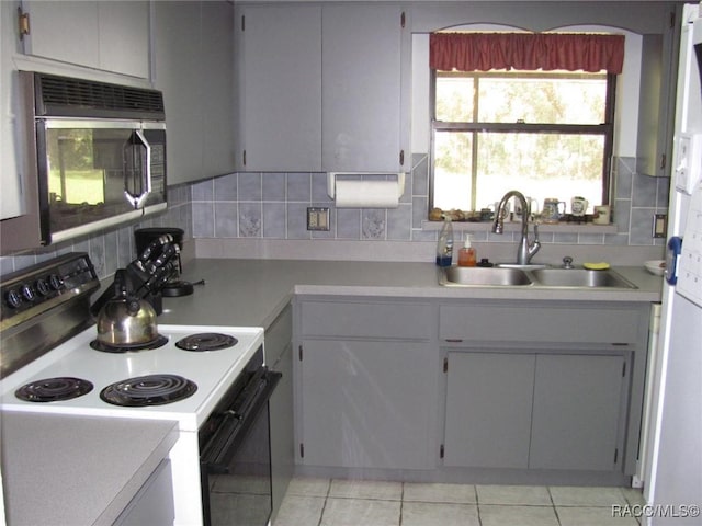 5198 N Sierra Vista Dr, Crystal River, FL 34428 - kitchen with electric range oven, stainless steel microwave, light countertops, and tasteful backsplash