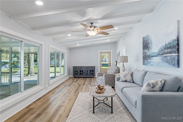 living room with vaulted ceiling with beams, ceiling fan, and light wood-type flooring